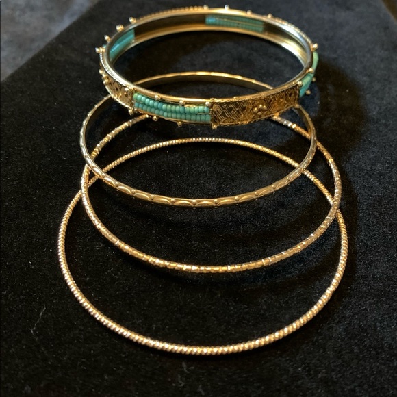 4 gold tone bangle bracelets. 1 w/turquoise seed beads 1/4” wide, 2.5” diameter - Picture 2 of 3